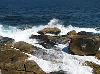 ocean water crashing on the rocky shore