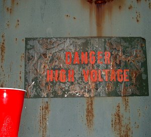 Danger High Voltage sign and beverage