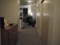 IMG_4775 View looking down the hall toward the living room.  The dresser sticks out from the wall about 8 inches.